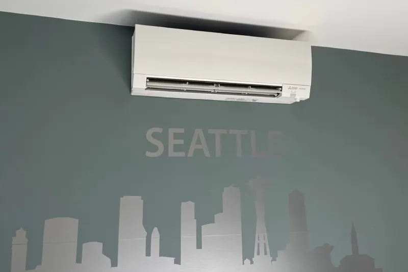 A wall decal with the Seattle skyline and the word "Seattle". Above it is a ductless mini split.
