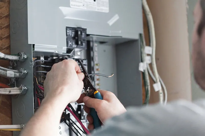 A technician working on an electrical panel.