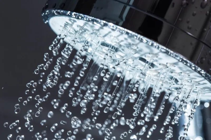 A shower head with water coming out of it.