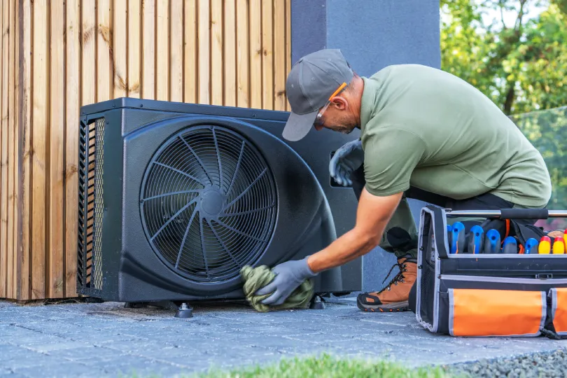 A technician working on a heat pump.