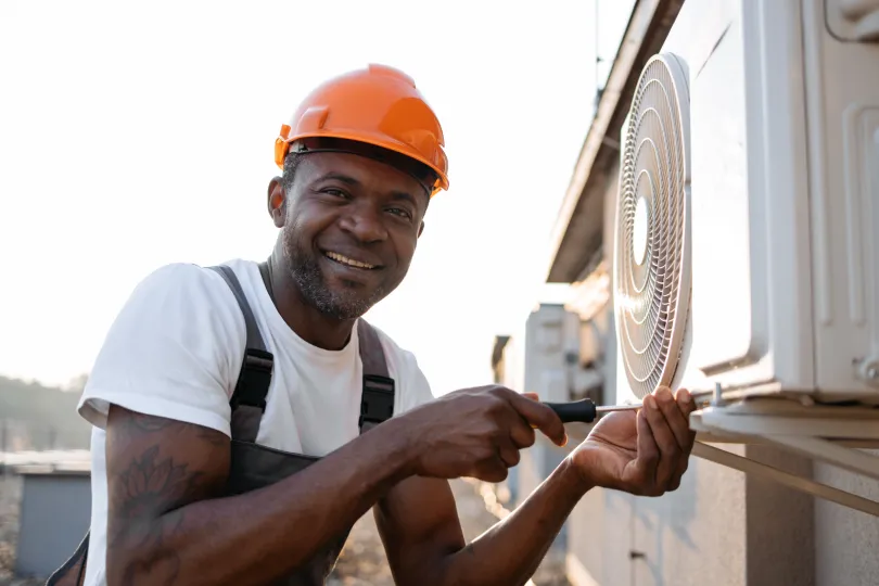 A technician working on an AC unit.