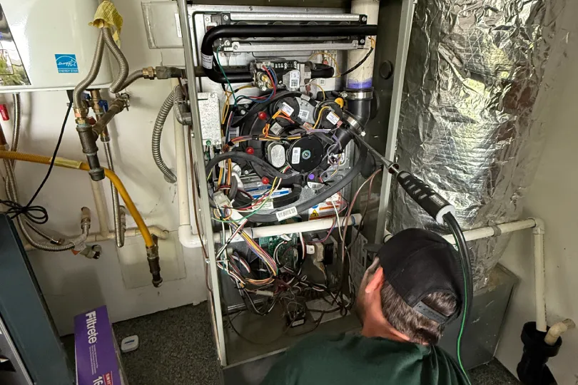 A technician working on a furnace.