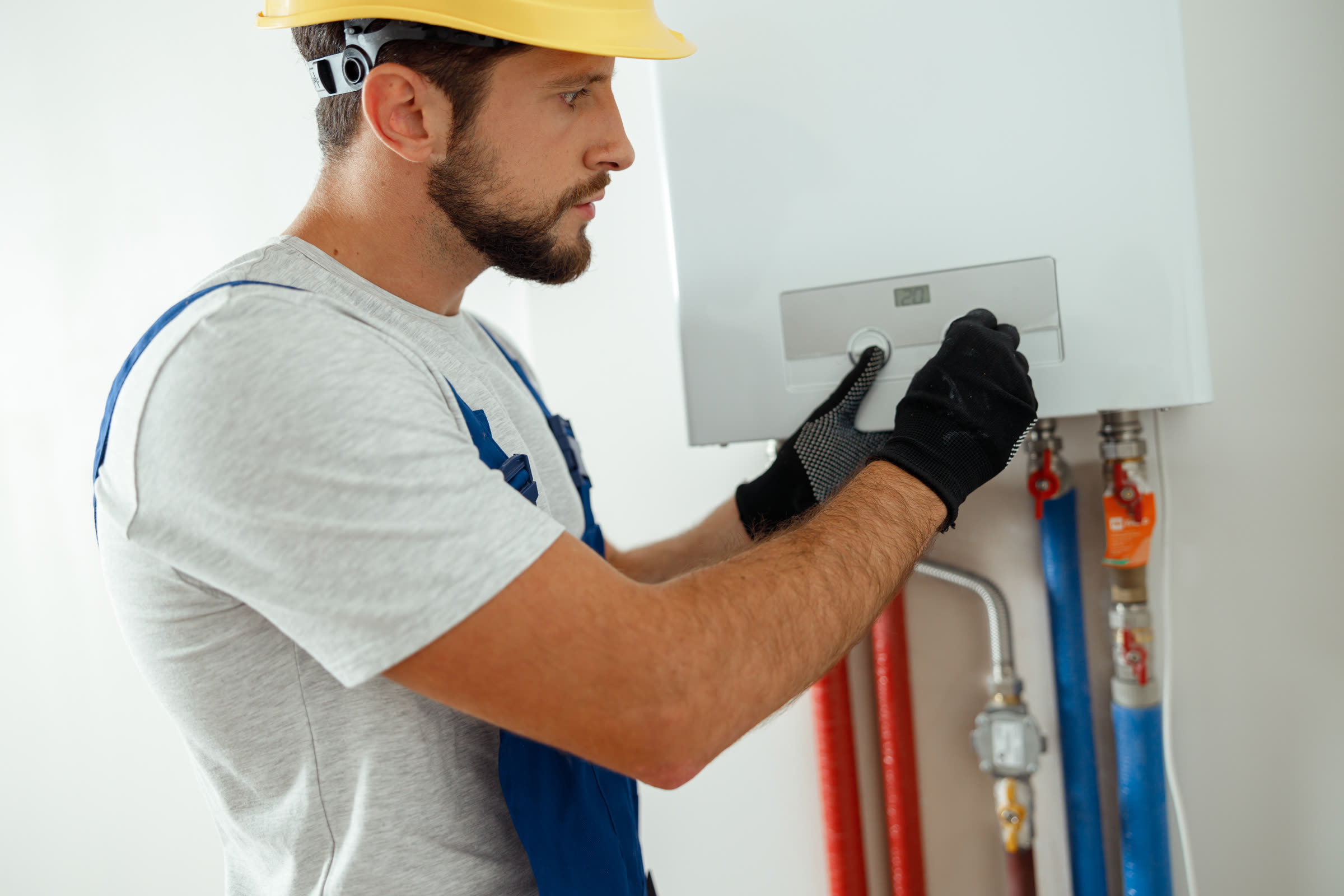Technician adjusting a gas heating unit