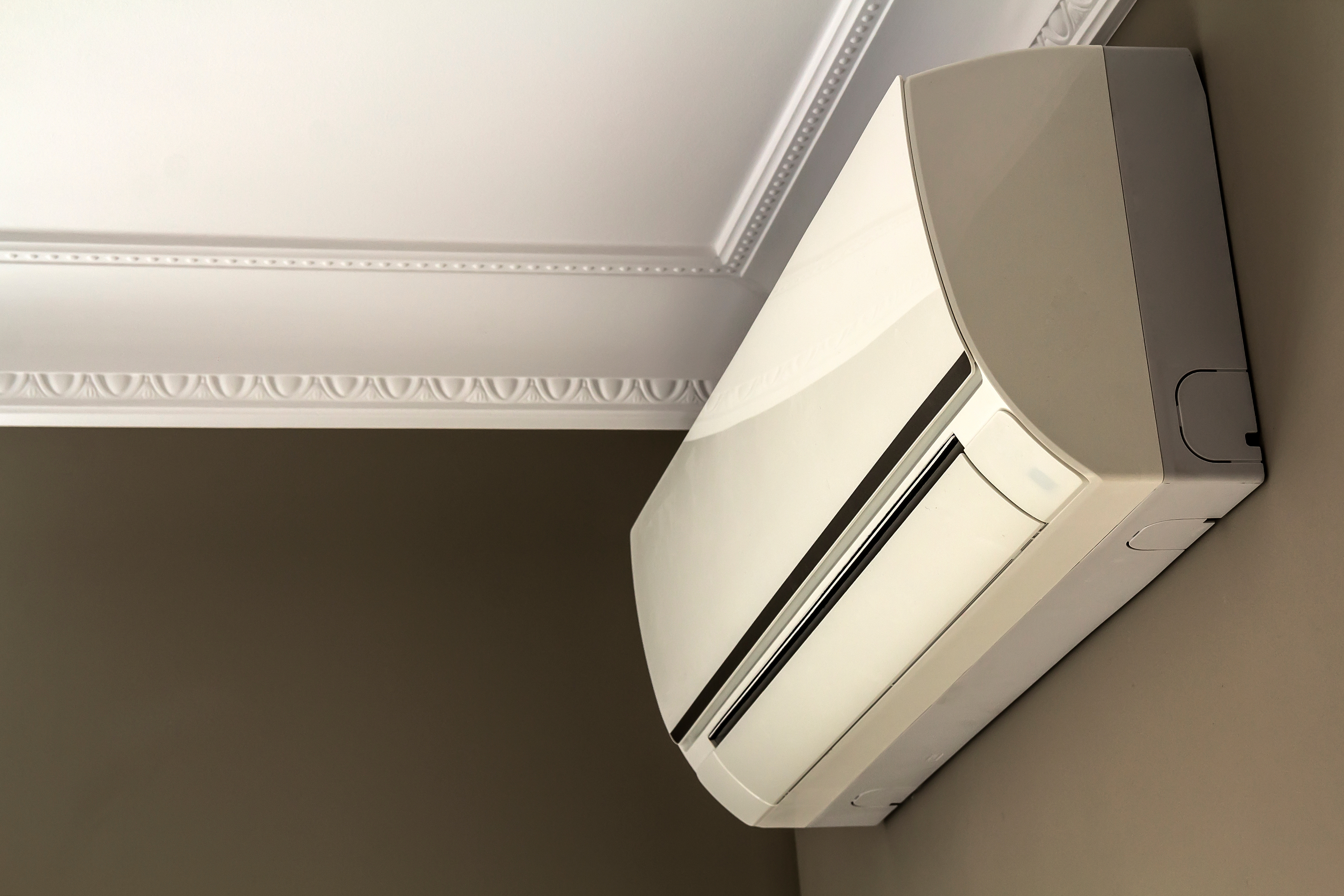 Ductless mini-split unit on a dark interior wall