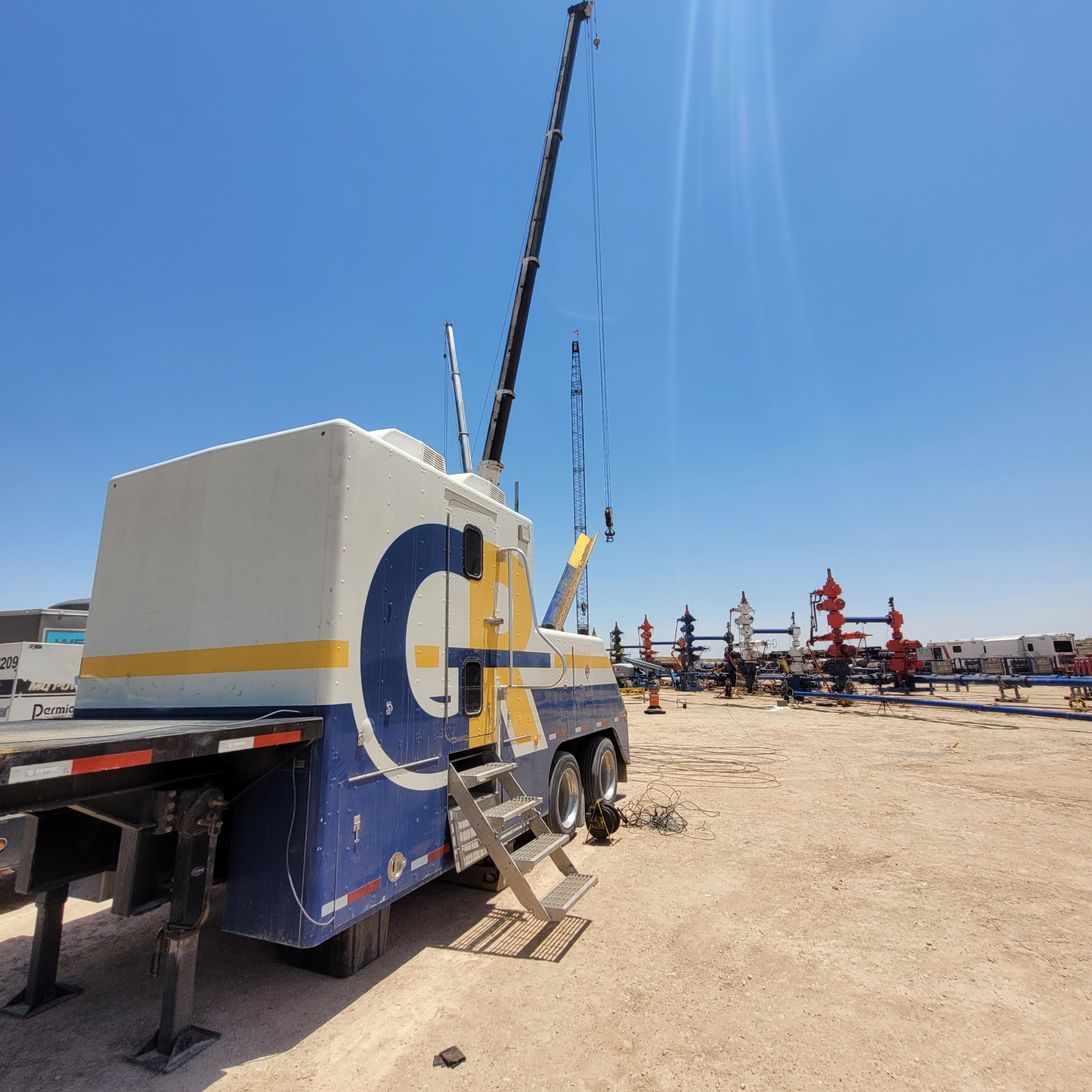 GR wireline unit with mast rigged up on a well pad