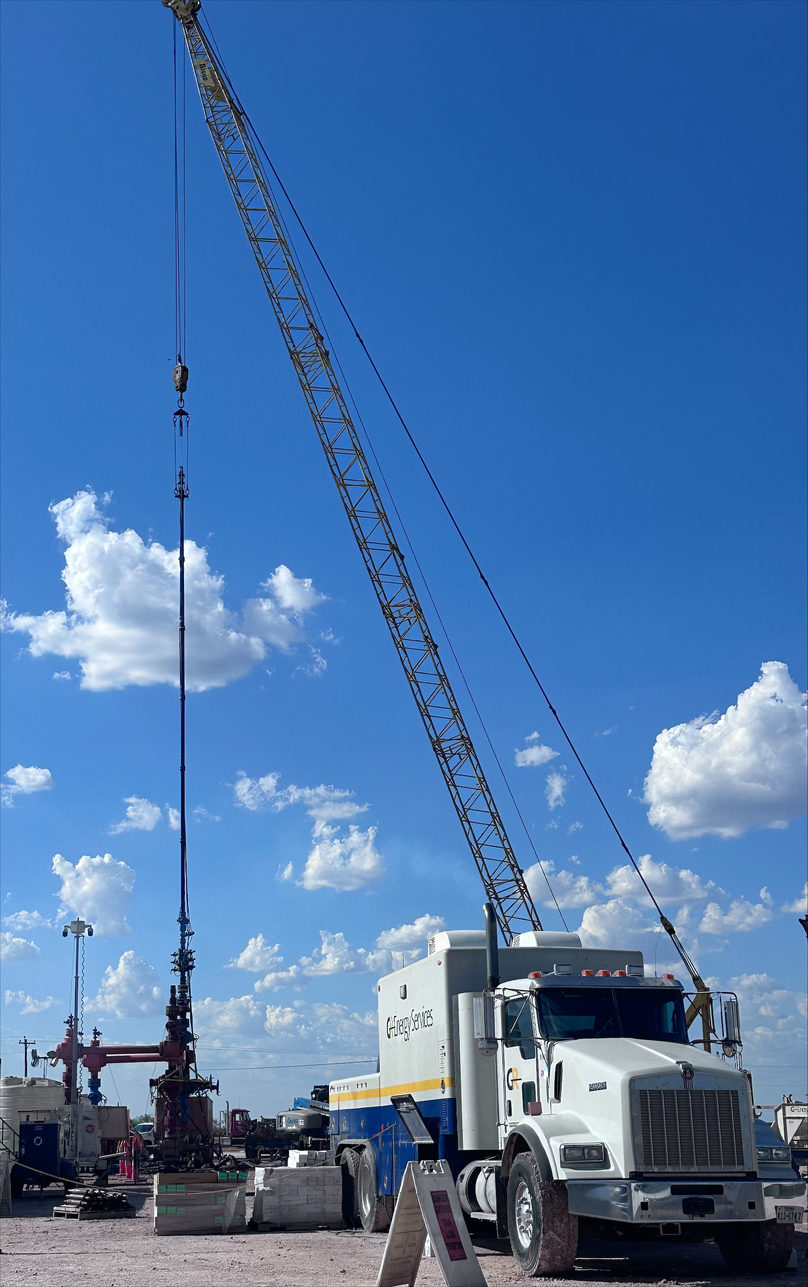 GR wireline truck and crane rigged up at a well site