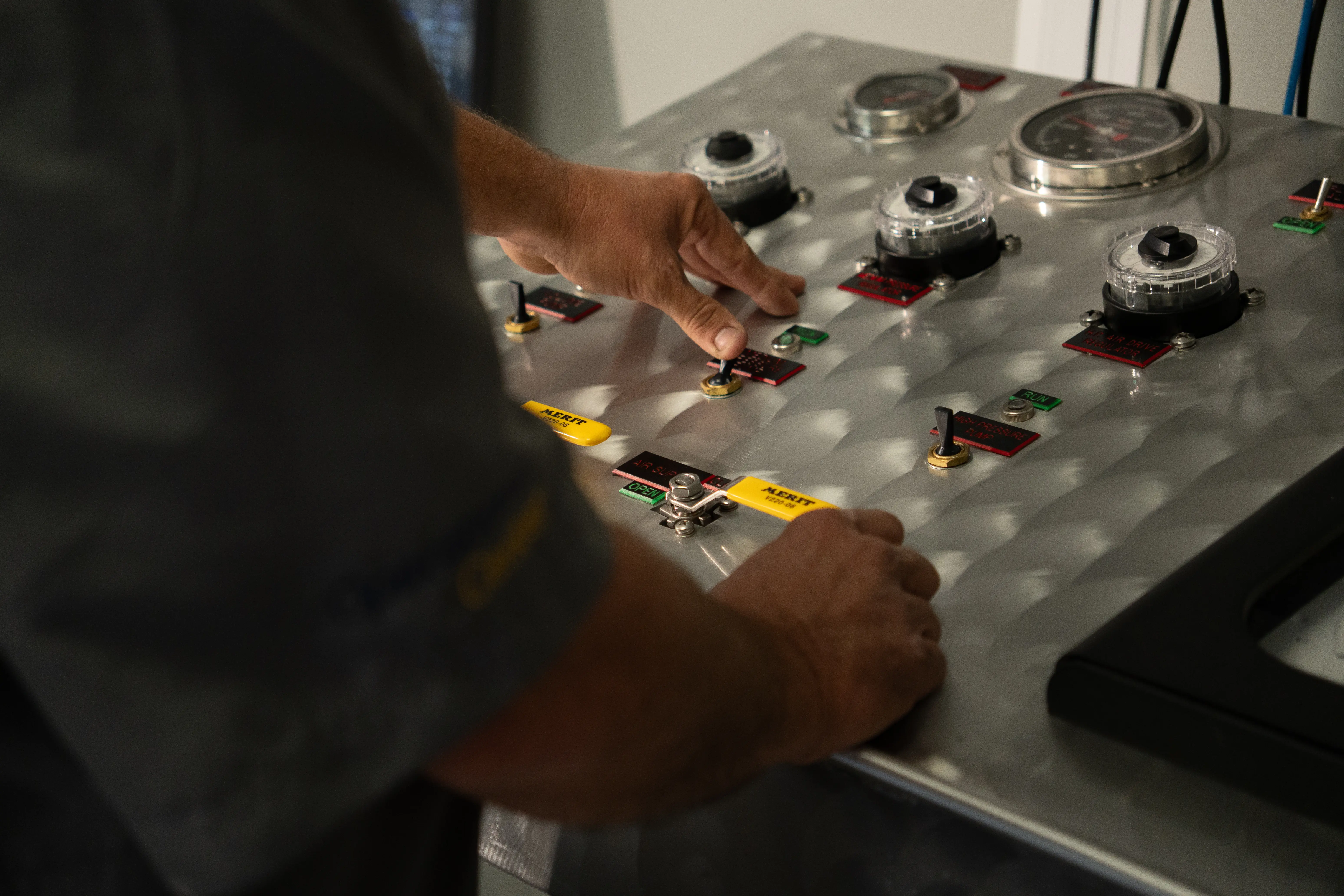 Operator adjusting controls on a wireline control panel