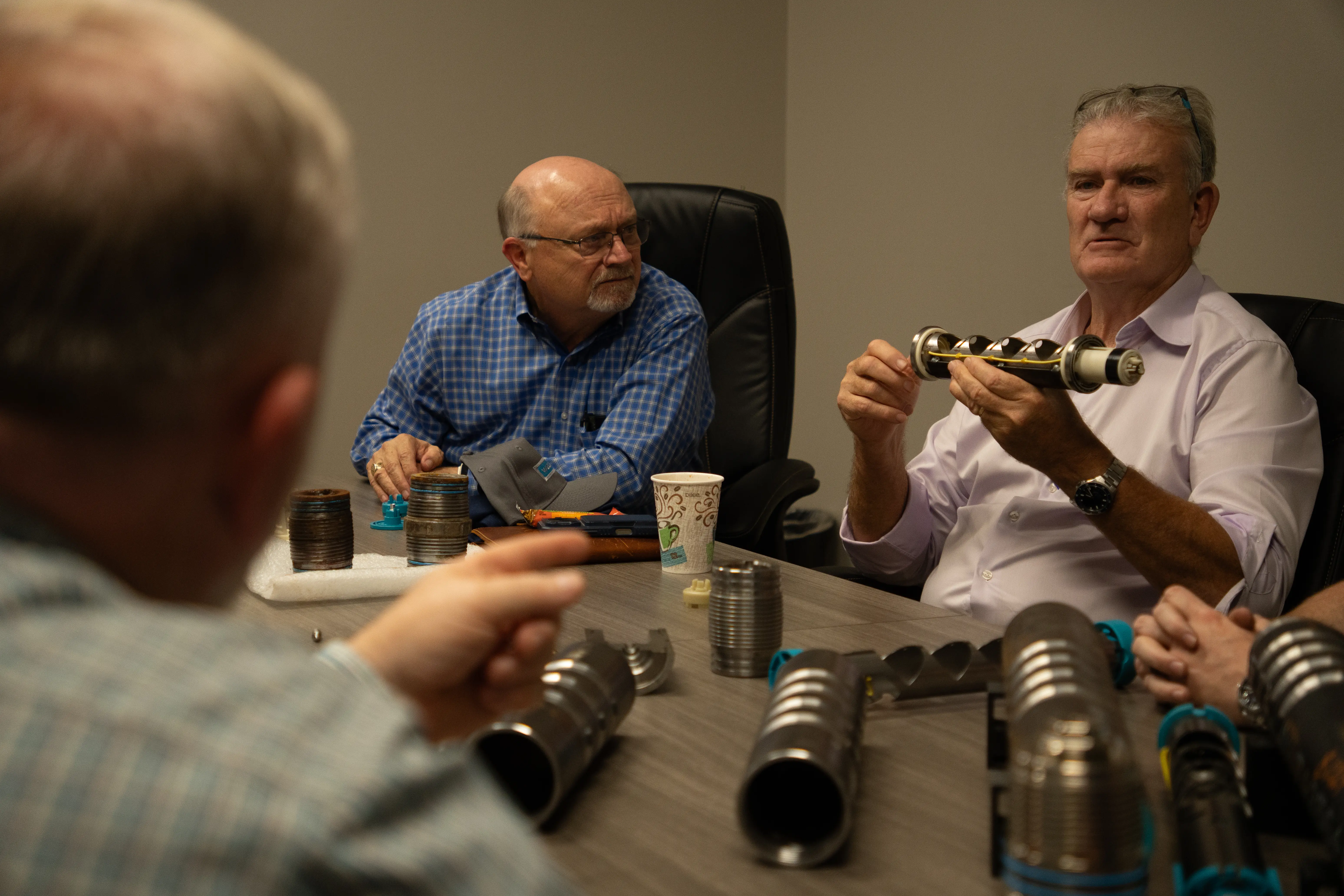 GR team reviewing perforating gun components at a conference table