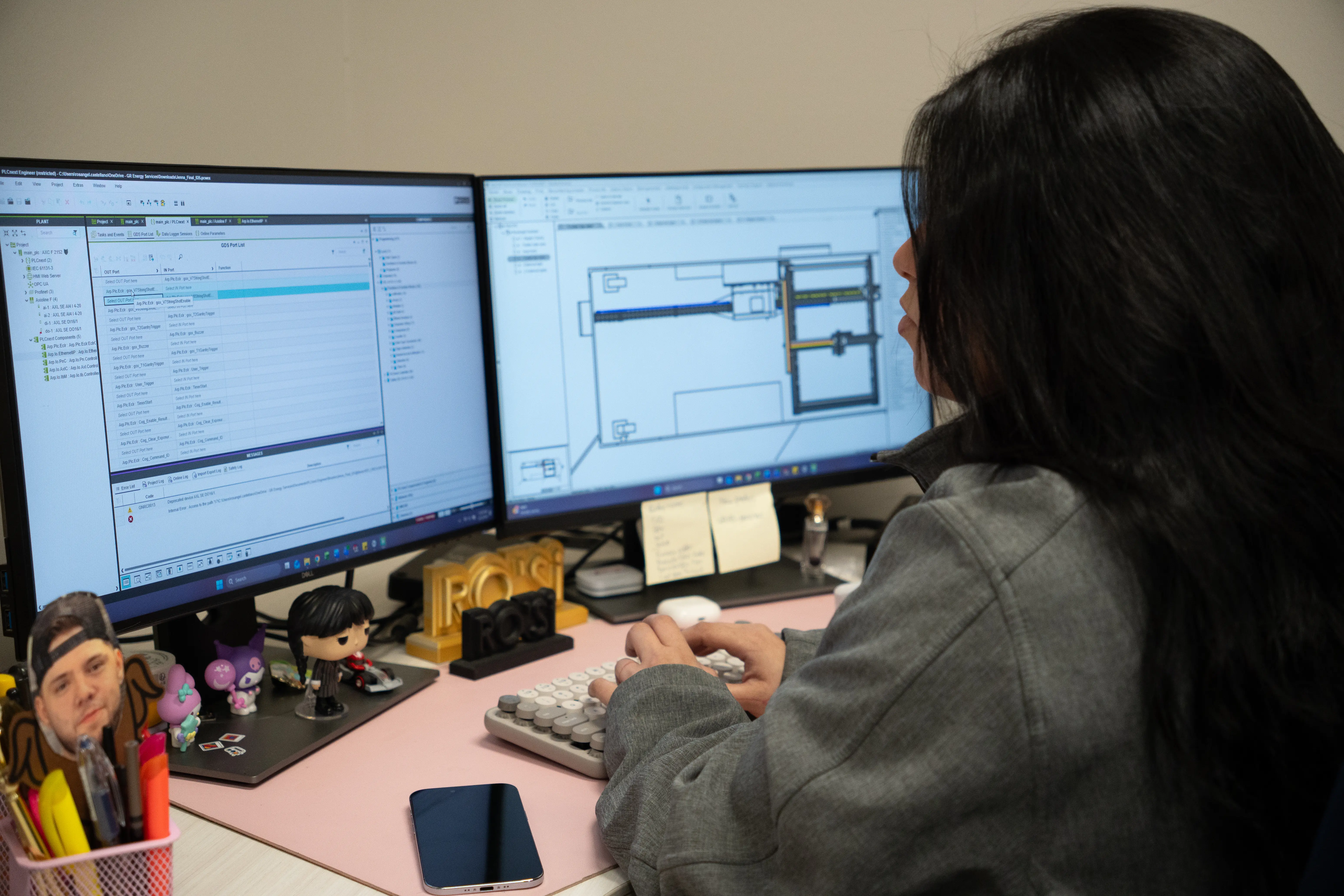Engineer working on design drawings at a dual-monitor workstation