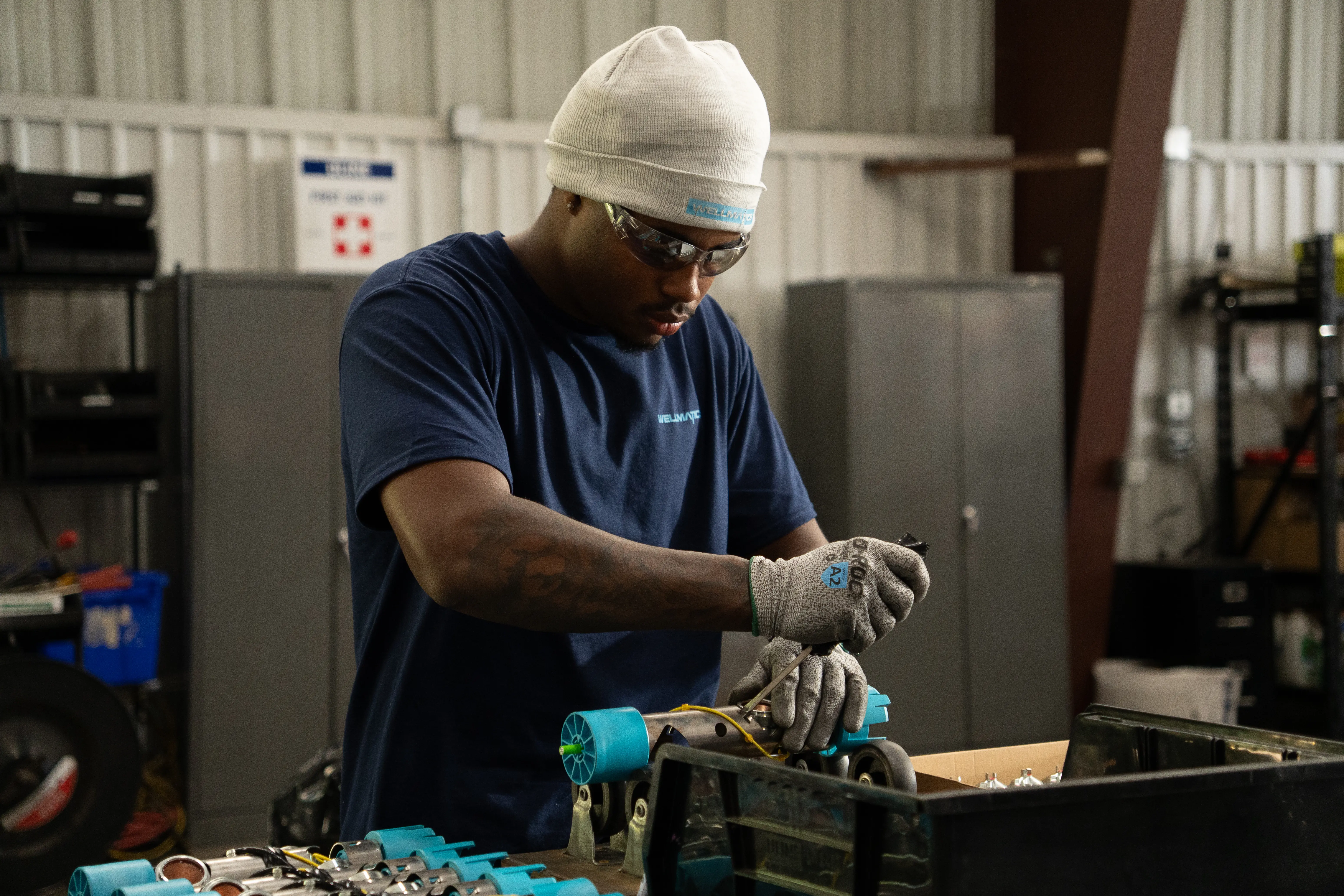 Shop technician wiring a component at a workbench
