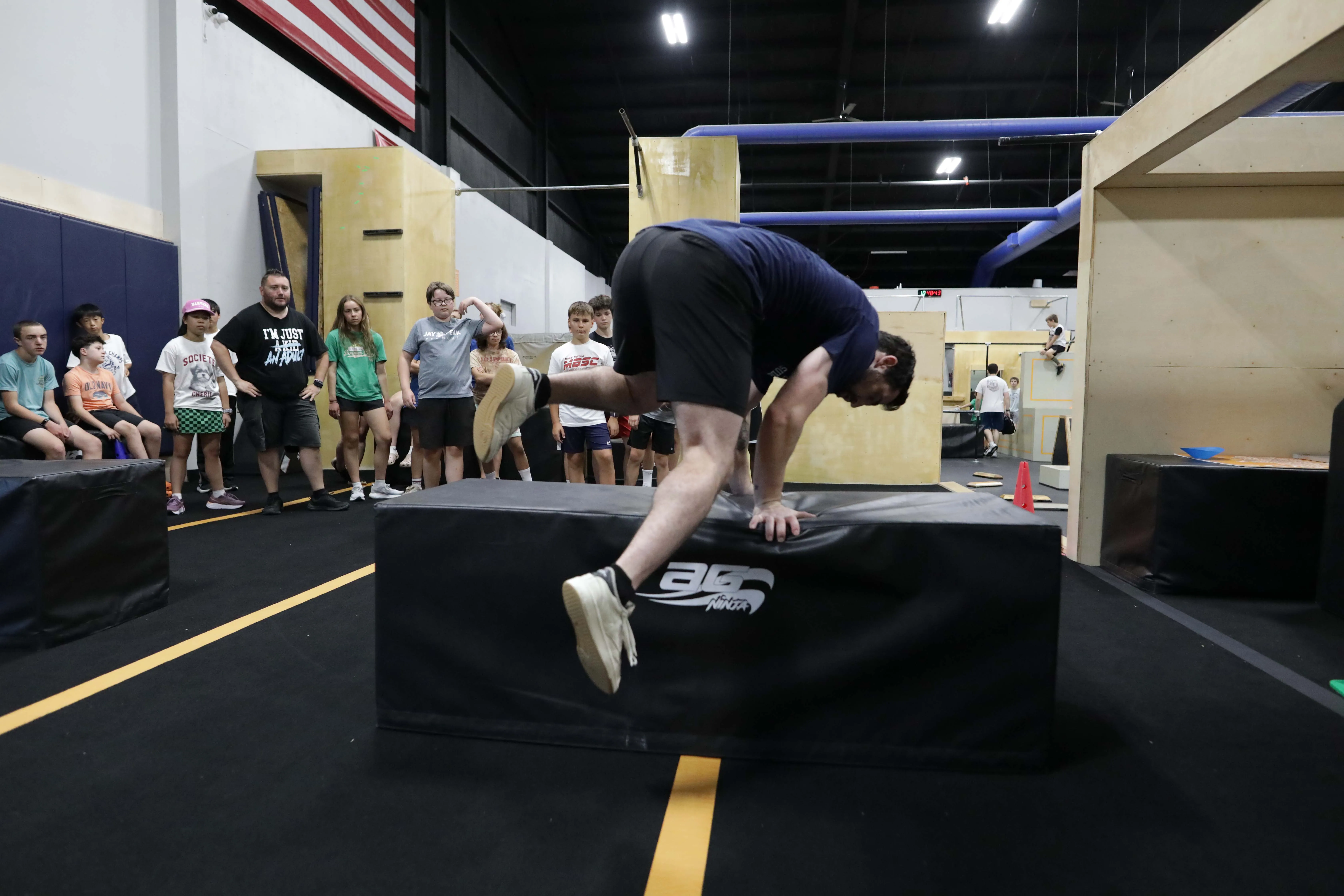Athletes training together on obstacles in a HUB Parkour class