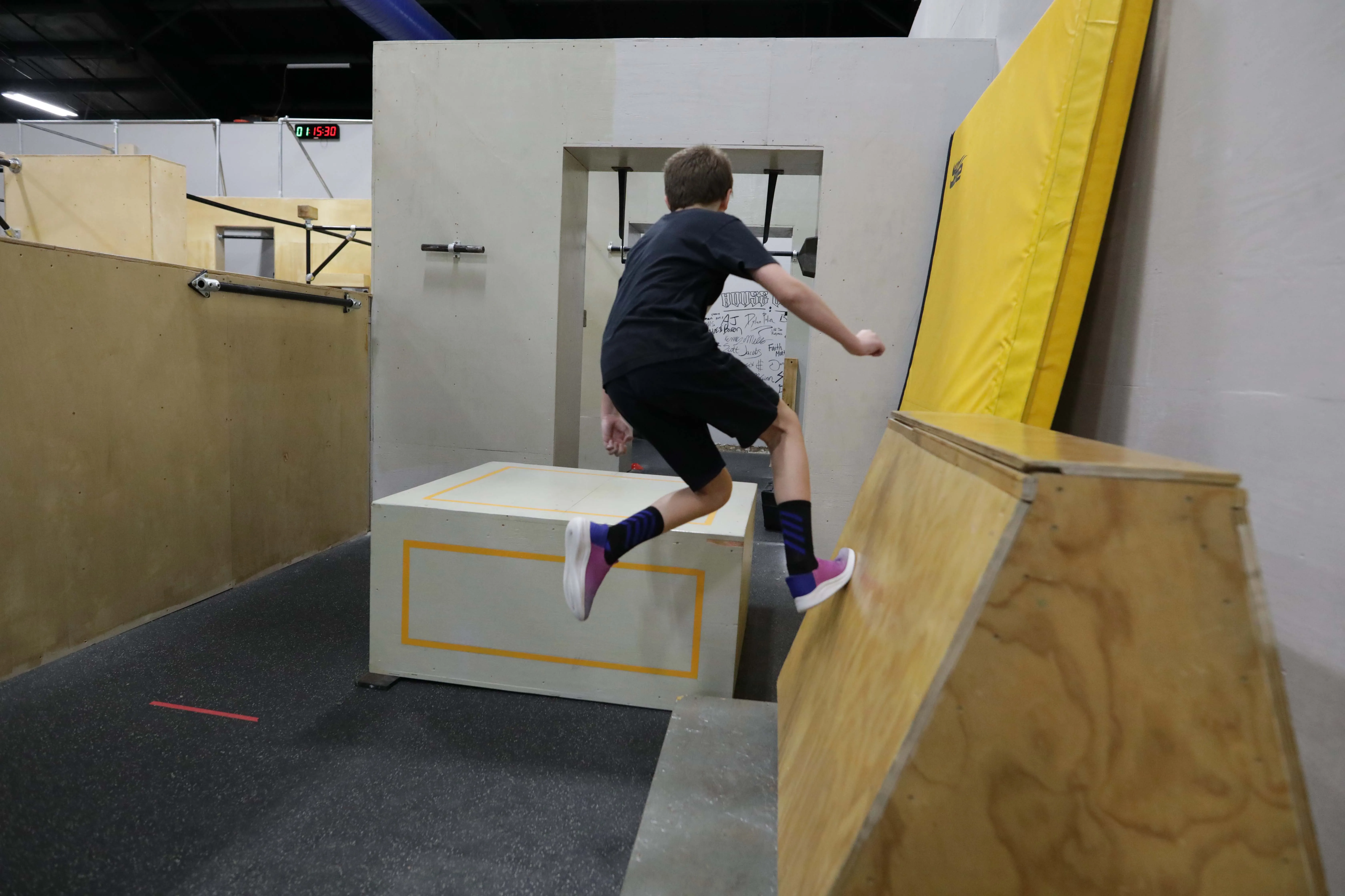 Kids training together on wooden obstacles at HUB Parkour