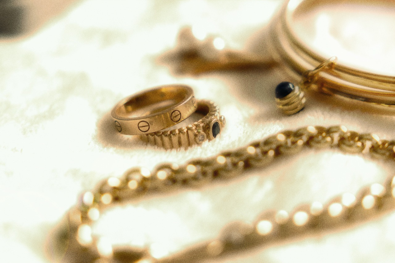Gold rings bangles and chain on cream cloth