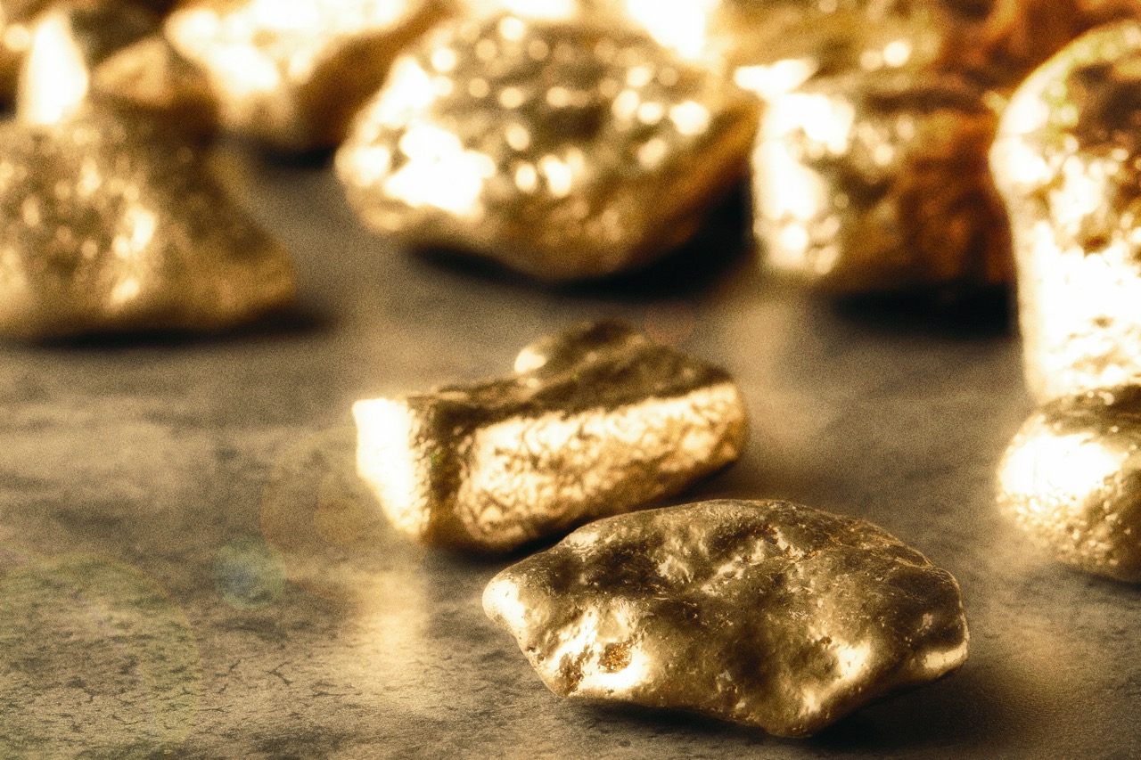 Rough gold nuggets on a stone surface