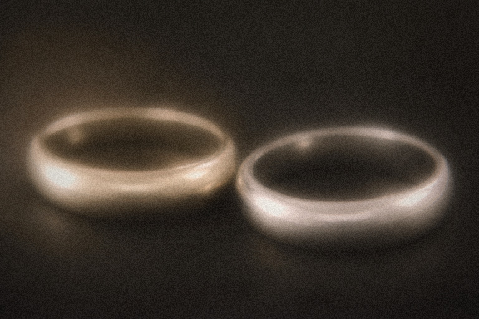 Diamond solitaire ring next to a white metal bracelet