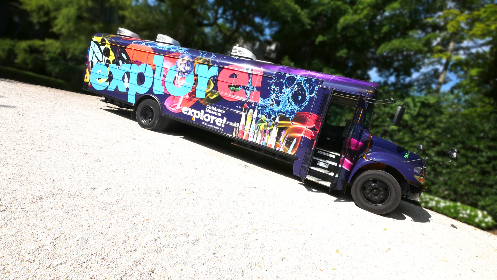 Explore! Mission Mobile bus with colorful science and art graphics