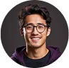A man wearing glasses and a purple hoodie stands, looking directly at the camera.