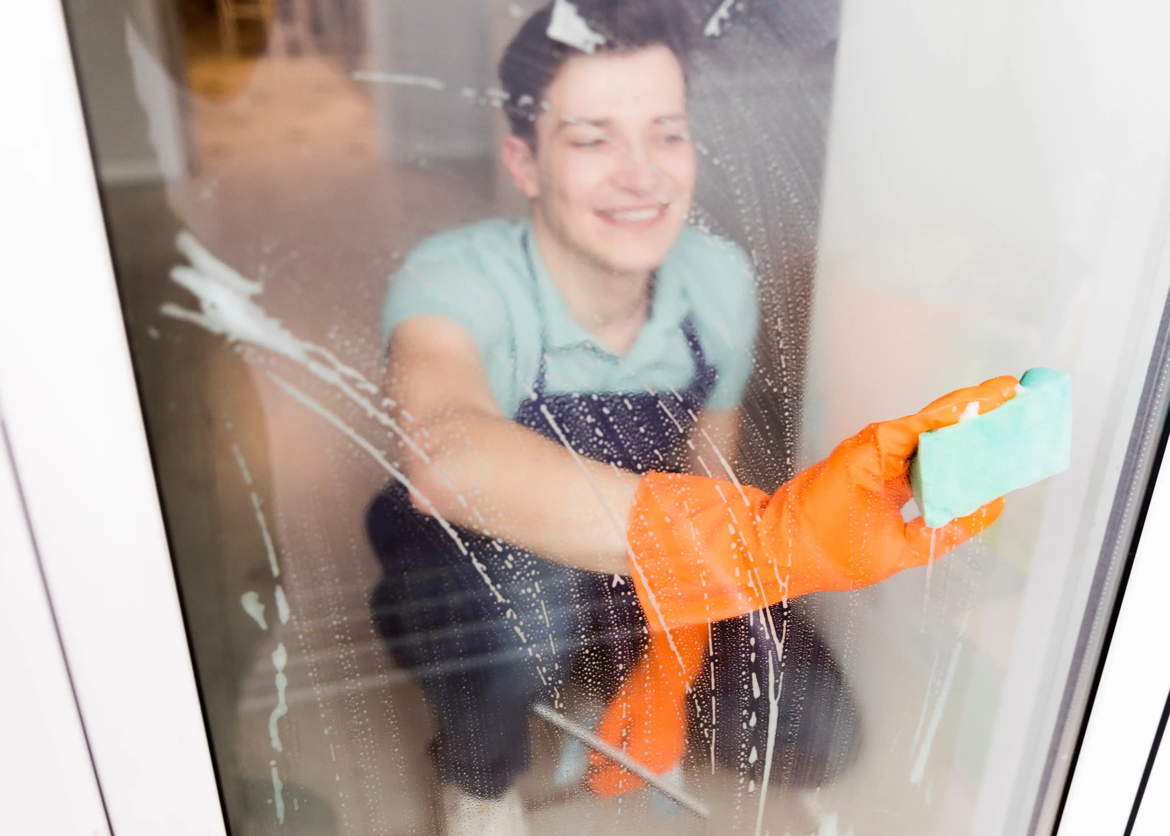 A person cleaning a window glass