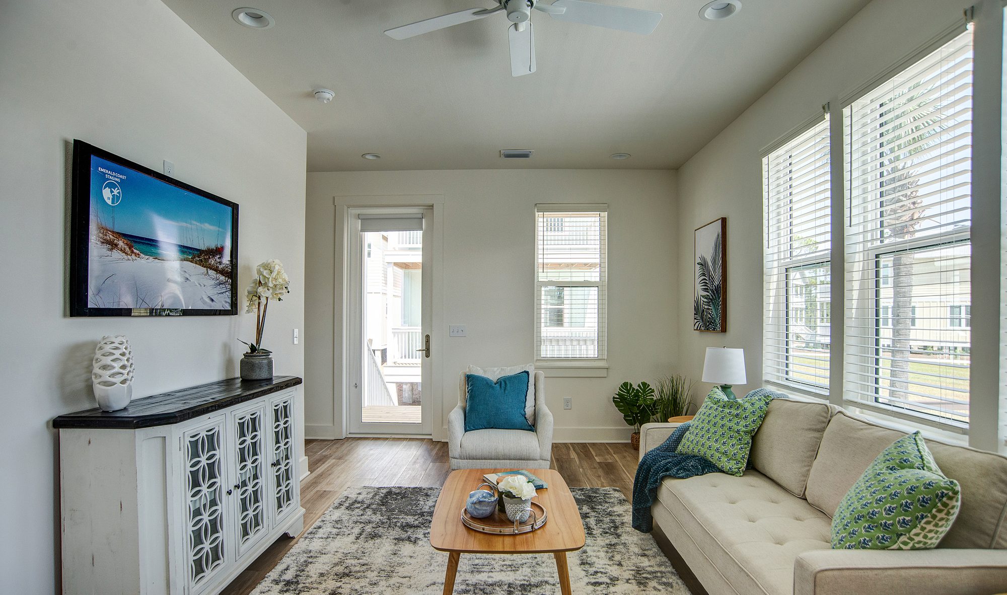 Open living room with coastal furnishings in a Barefoot Cottages home