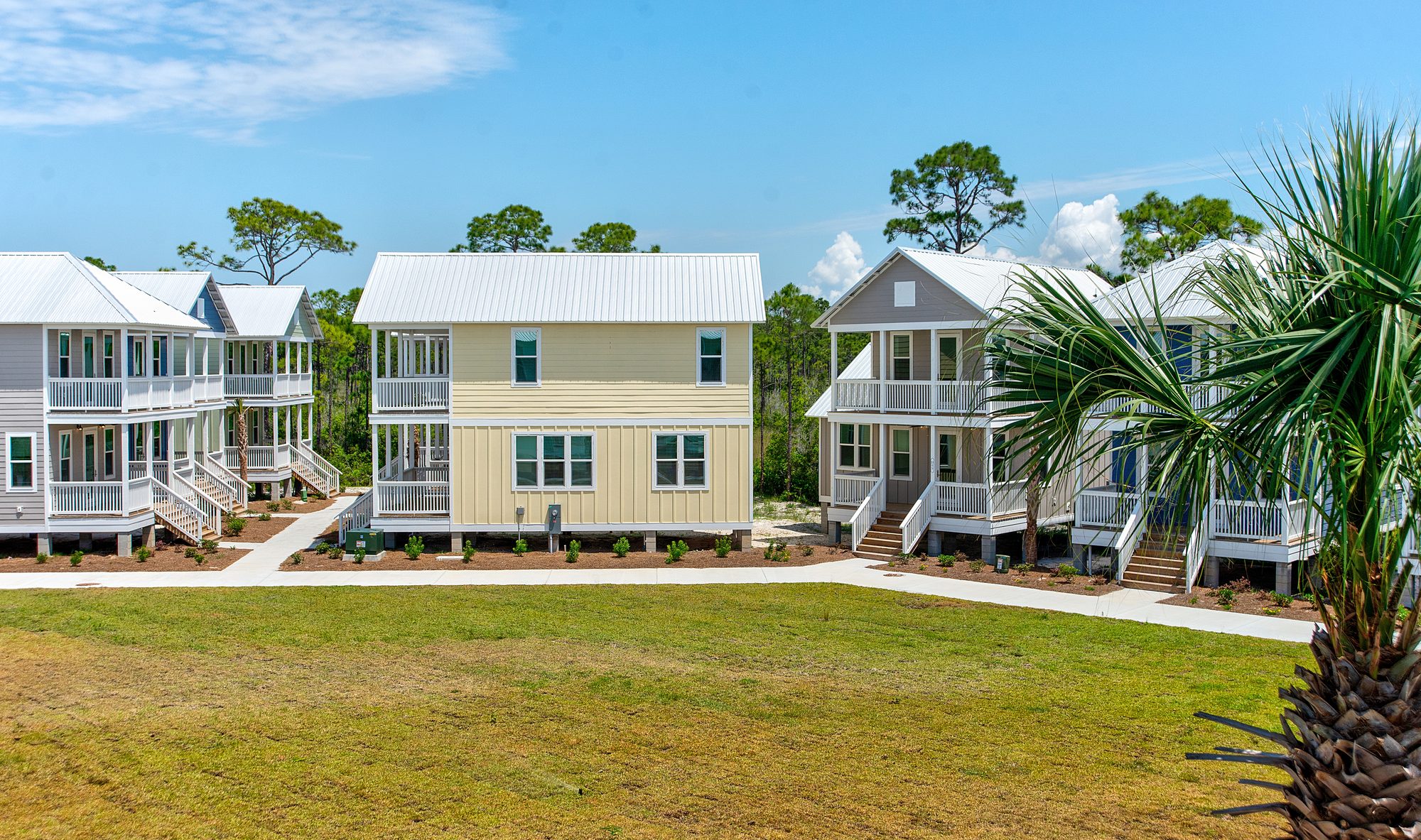 Pastel cottages and lawn at Barefoot Cottages in Port St. Joe