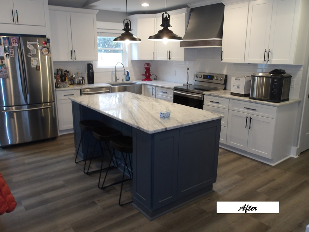 Kitchen with a new island and flooring after water damage repair
