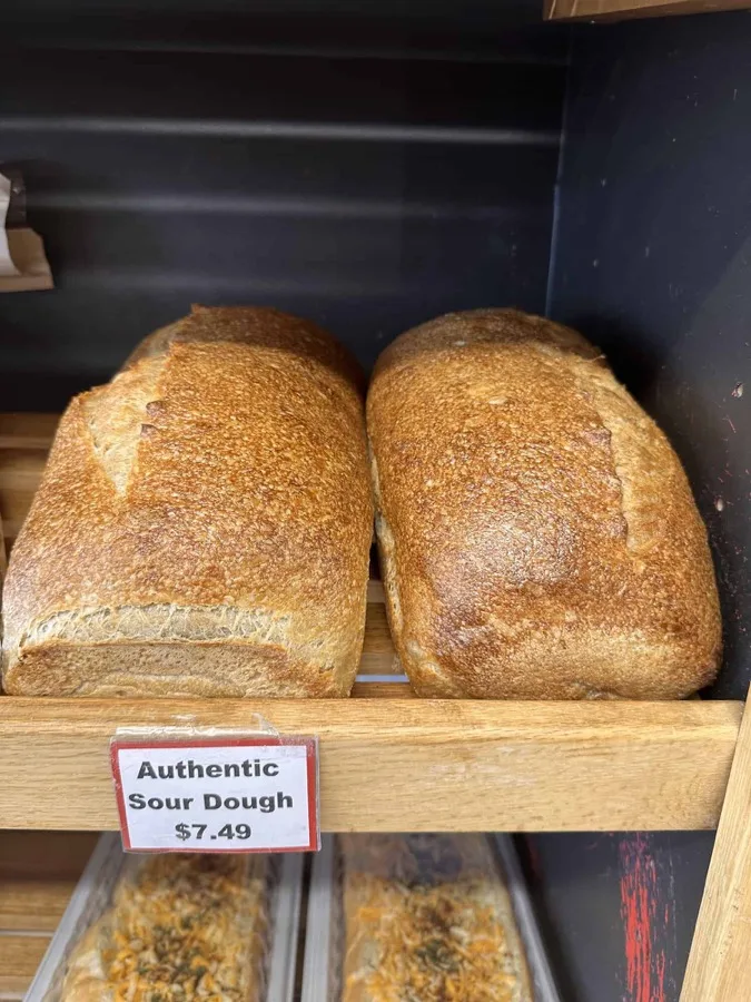 Two loaves of authentic sourdough on a wooden board