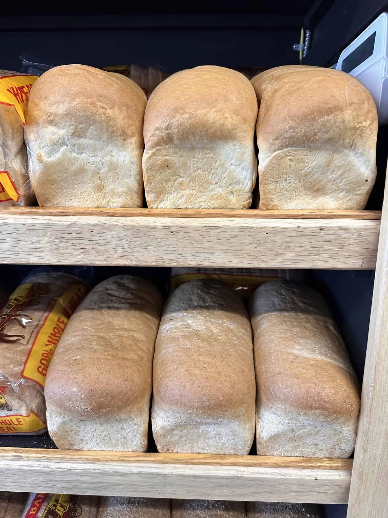 Shelves of freshly baked bread loaves at Coaldale Bakery