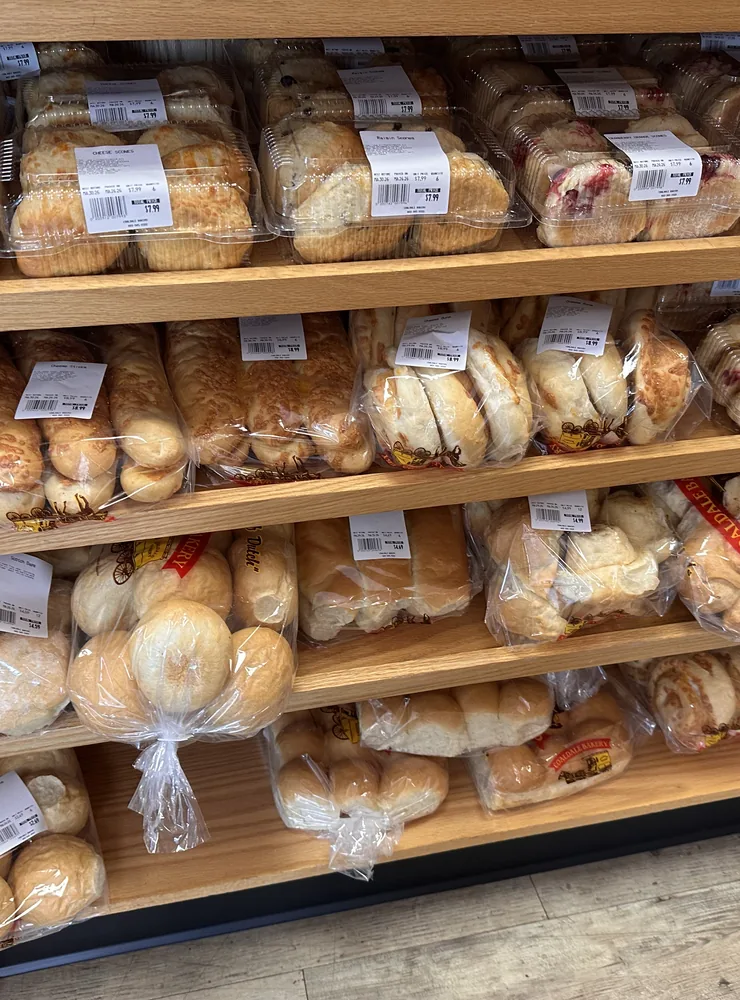 Loaves of bread lined up on the wooden shelves in the Coaldale Bakery store