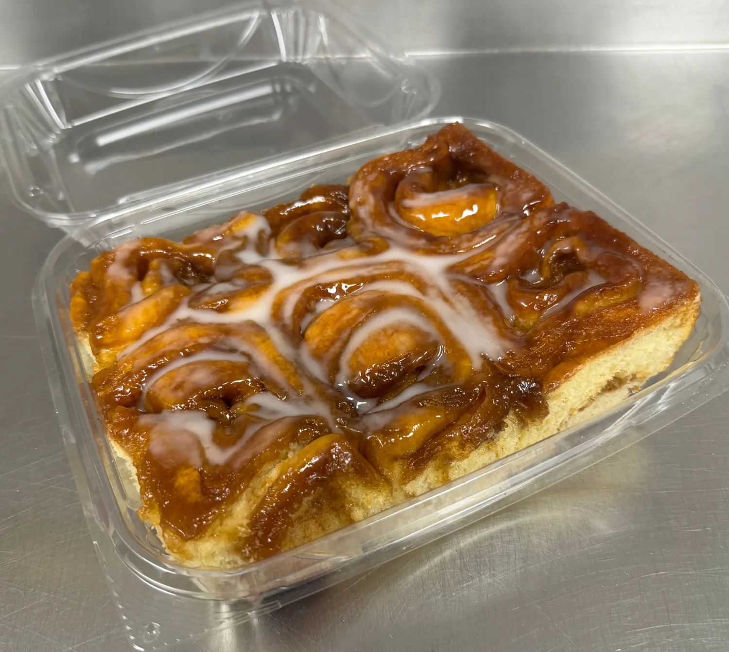 A tray of glazed cinnamon buns