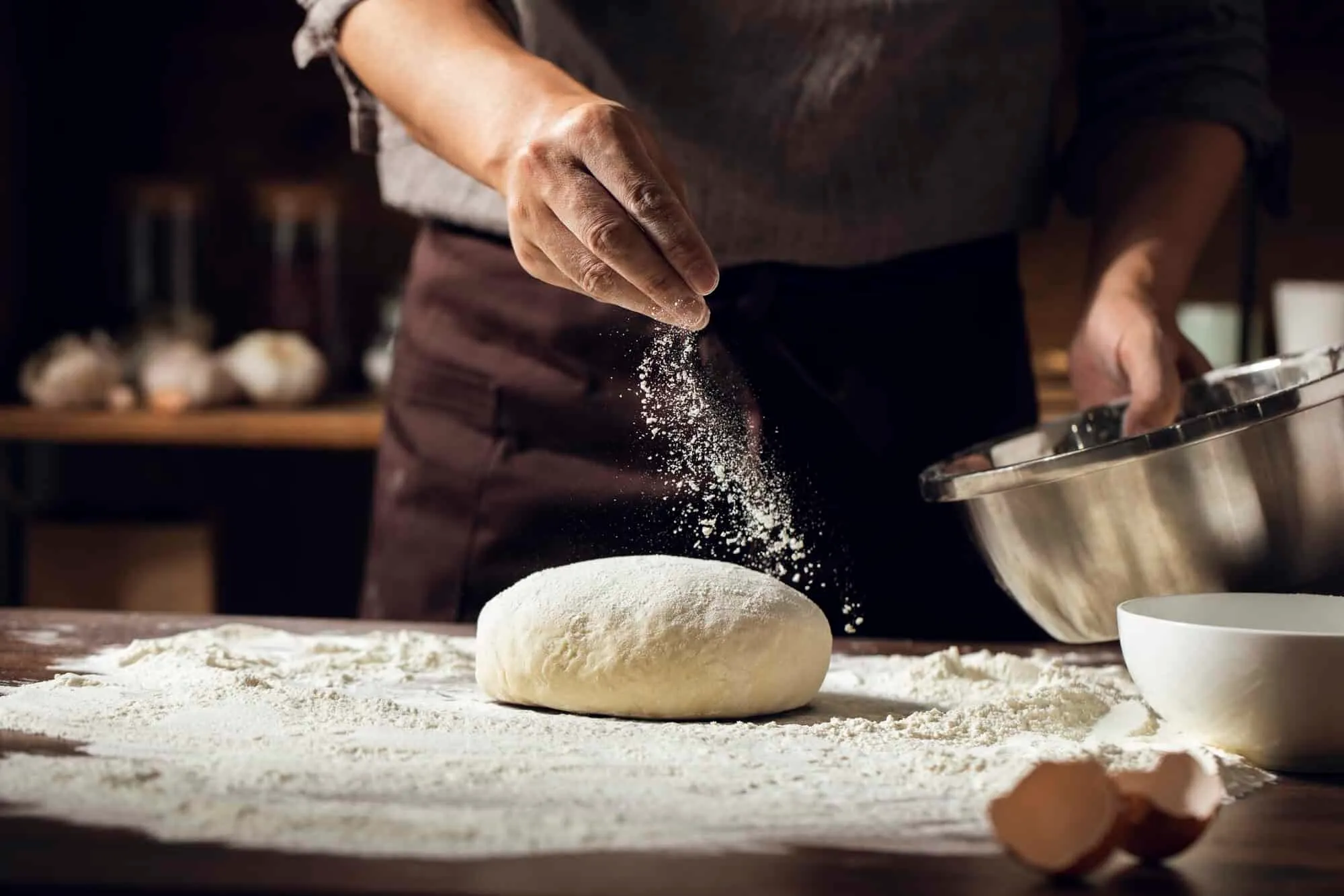 Hands shaping dough beside freshly baked pull-apart bread