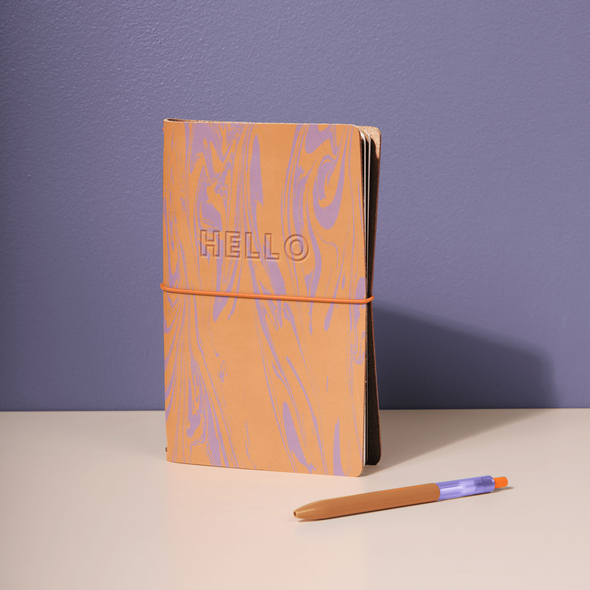A curated new hire welcome kit laid out with branded apparel, an insulated bottle, and a notebook