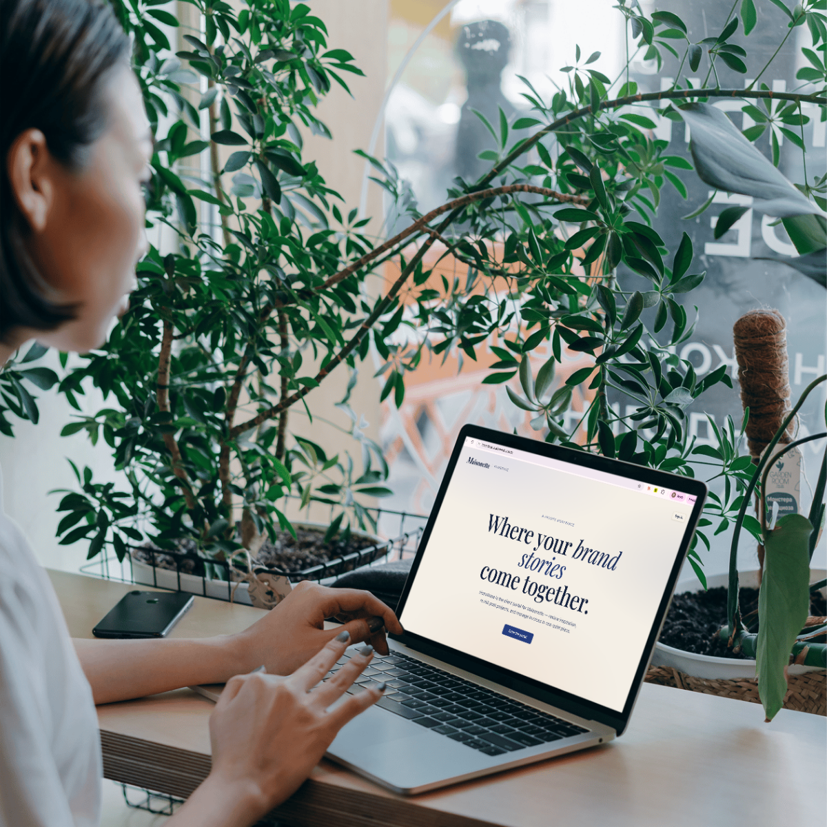 A person browsing a laptop displaying a branded client portal homepage, styled as a company store mockup
