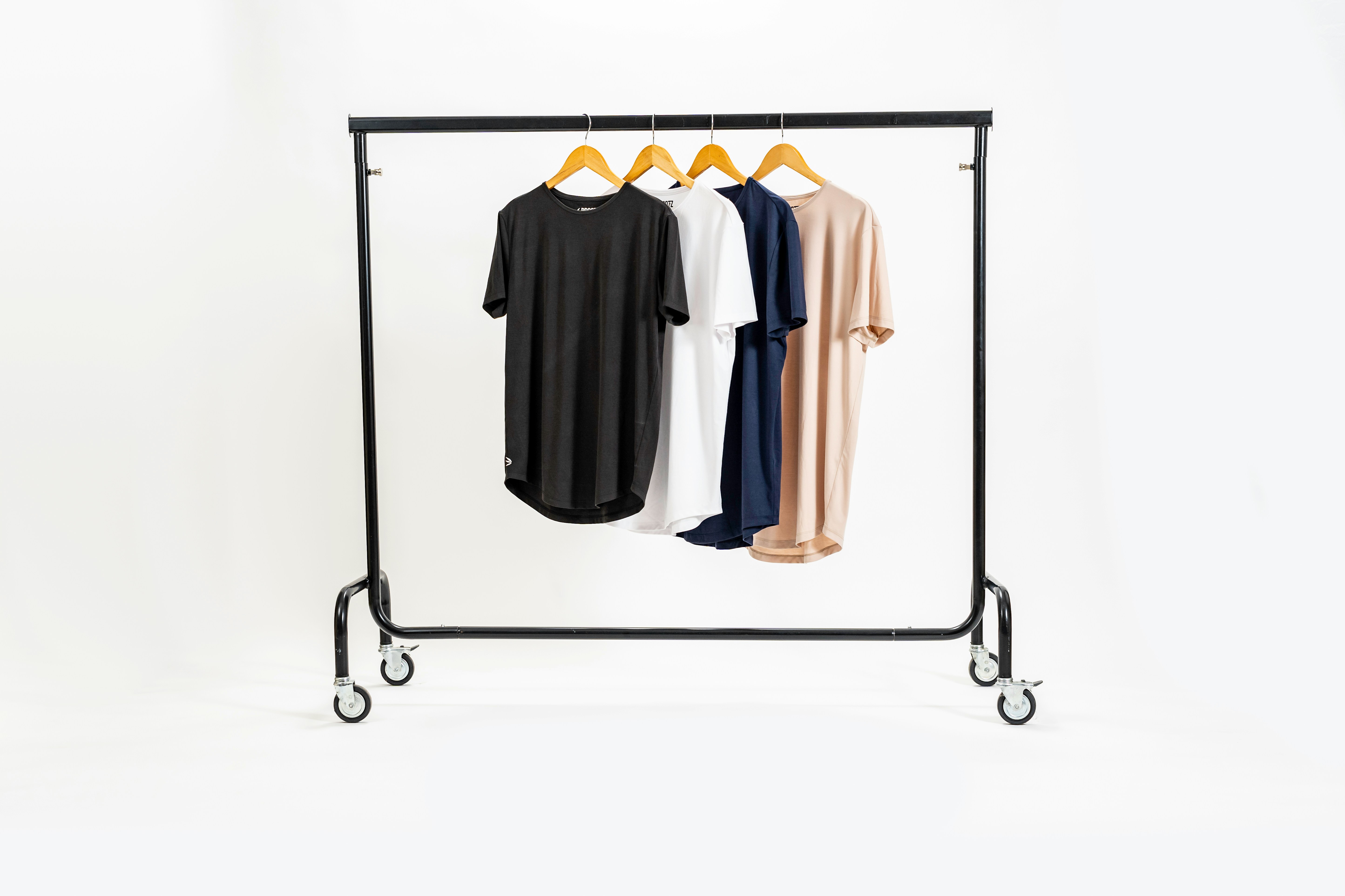 A small selection of high quality branded apparel and accessories arranged on a neutral surface