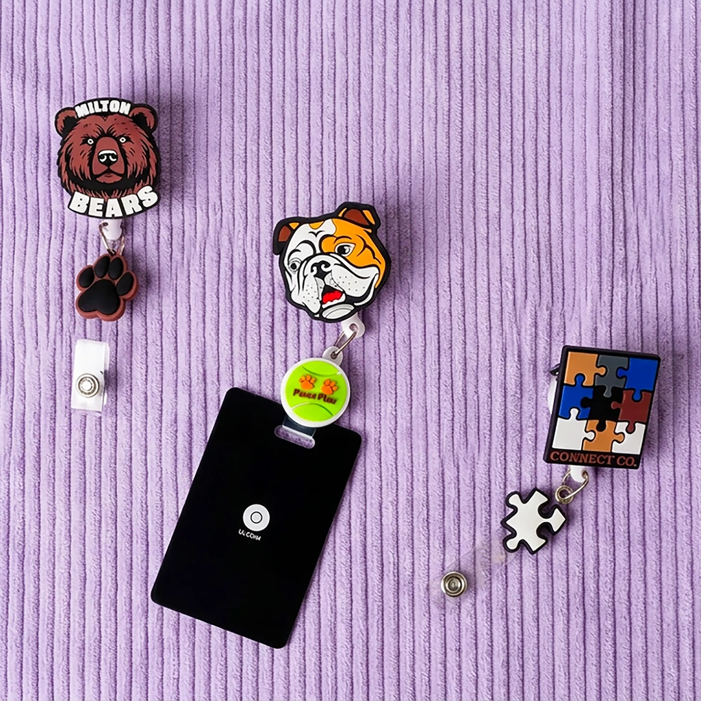 A conference booth table with collectible enamel pins and personalized branded merchandise on display