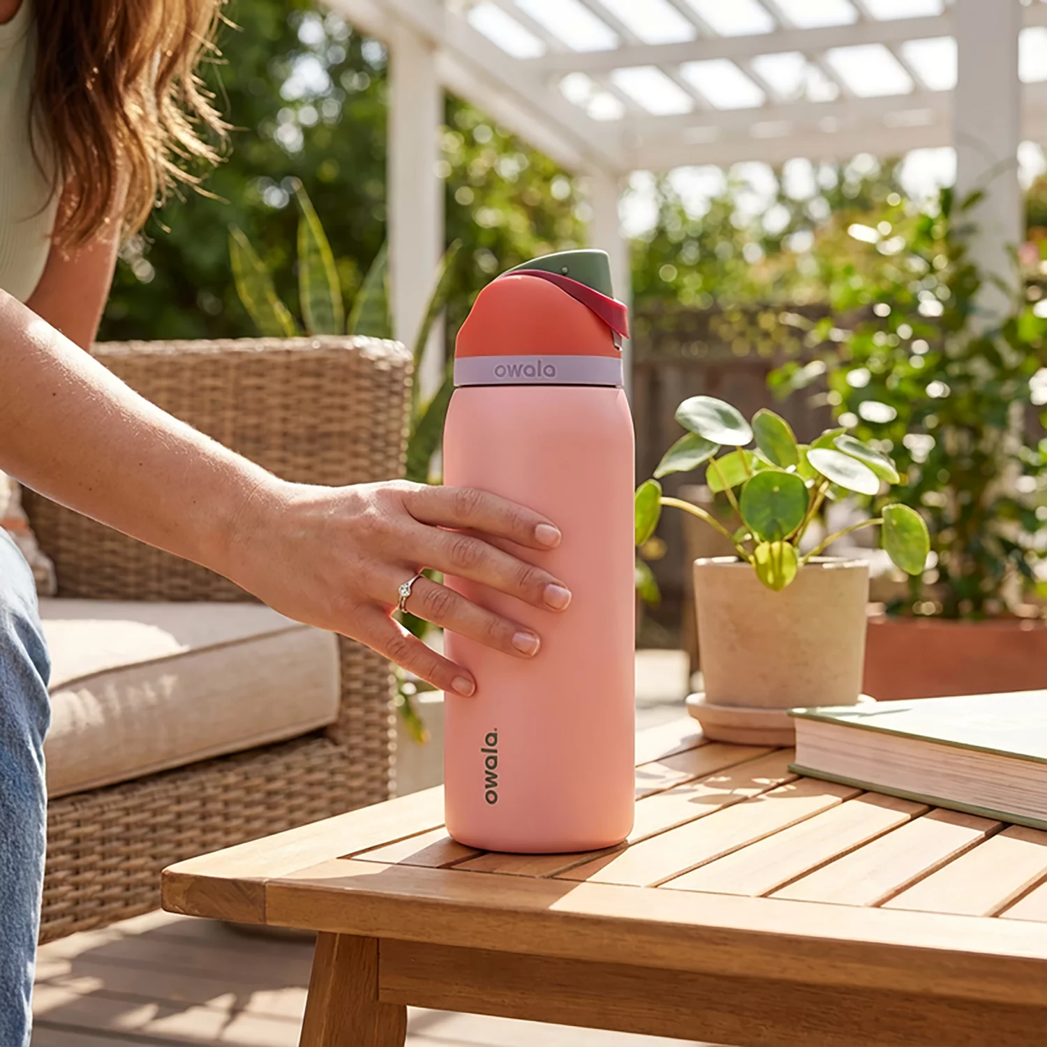 A new hire onboarding gift box with folded branded apparel, a steel bottle, and a handwritten note
