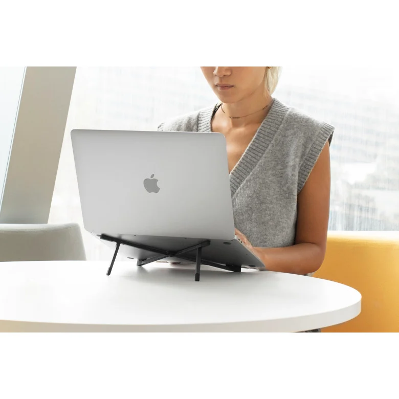 A laptop showing a company swag store product page with branded apparel and accessories at several price points