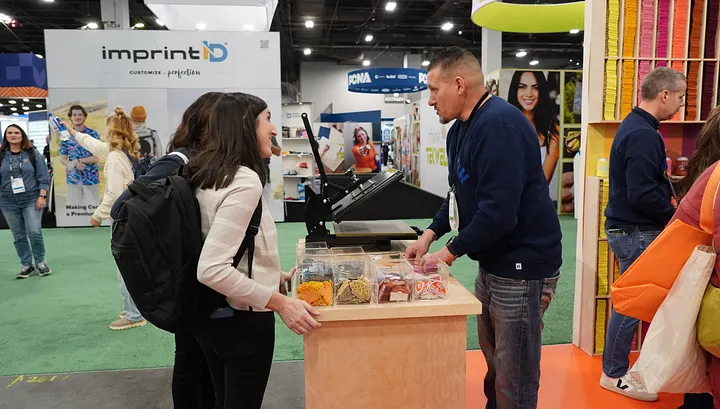 A trade show booth with a small group meetup, a reaction game and a staffed conversation area