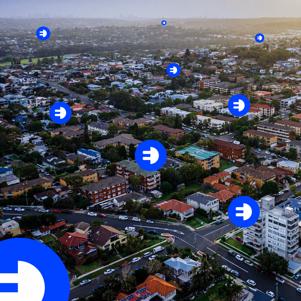 Aerial view of a suburban neighbourhood with blue location markers scattered across the area.