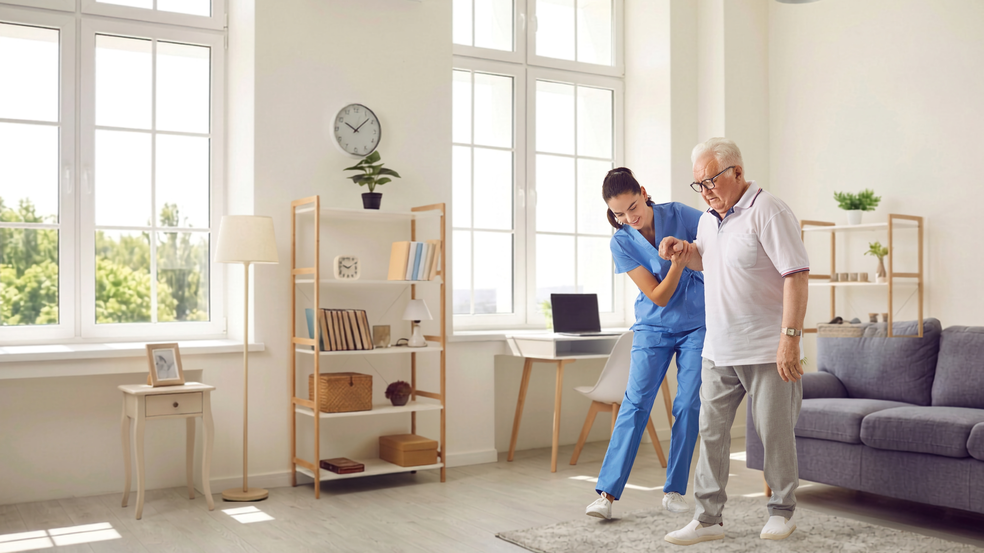 A registered physiotherapist supporting an older adult with walking practice at home