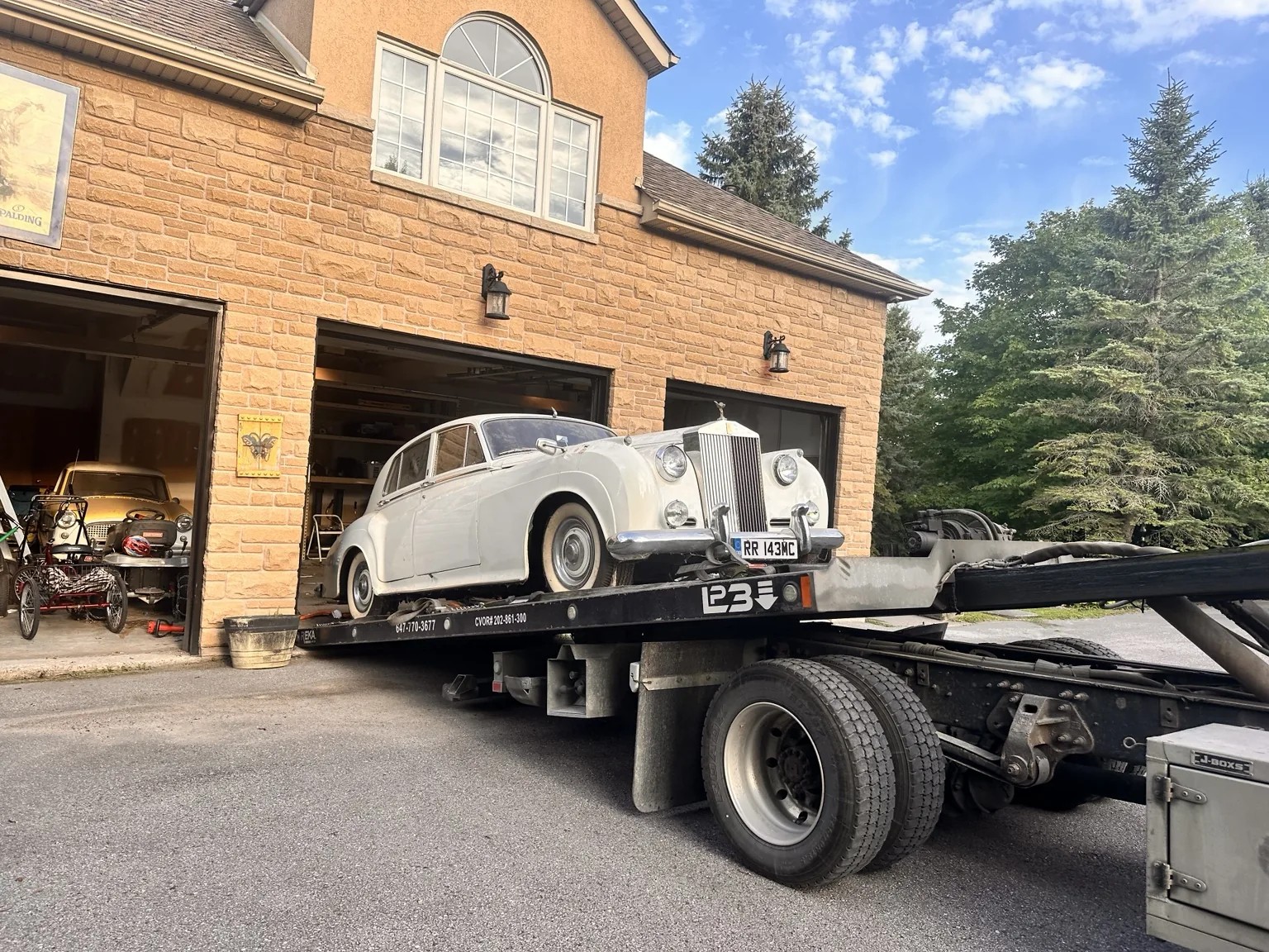 Vintage Rolls-Royce convertible transported by Triple S Towing flatbed