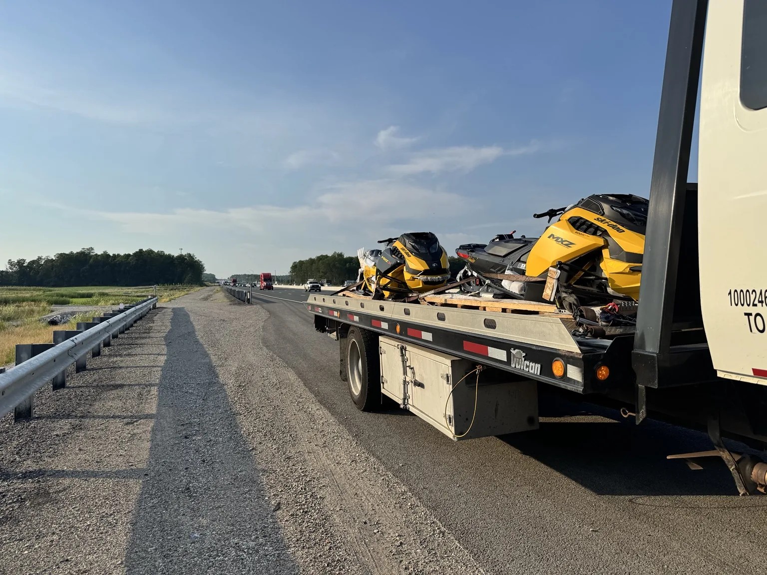 ATV and recreational equipment transported by Triple S Towing flatbed