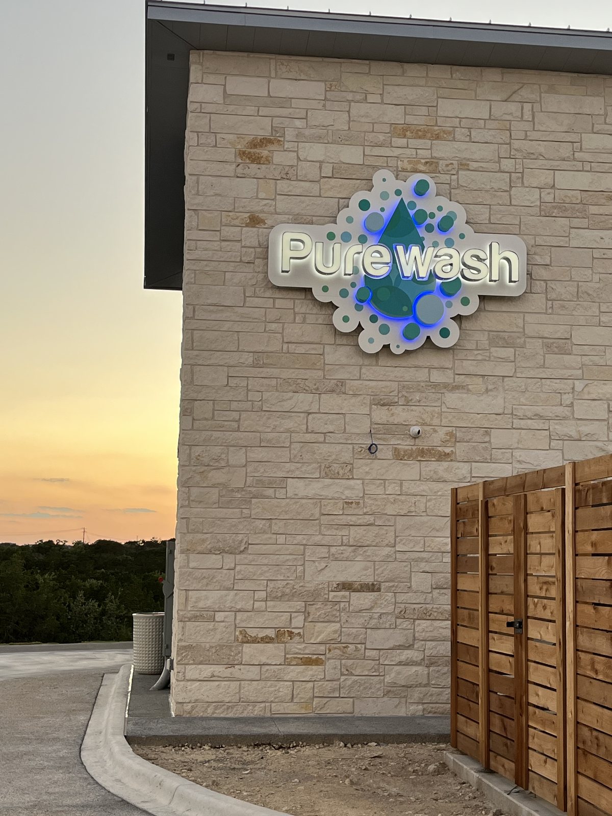 The Purewash sign lit at dusk