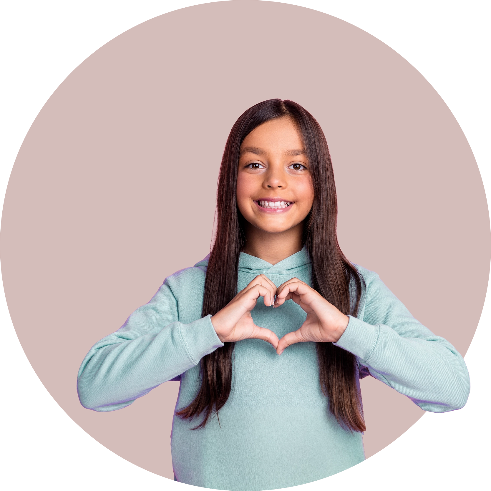 A girl smiling and making a heart shape with her hands
