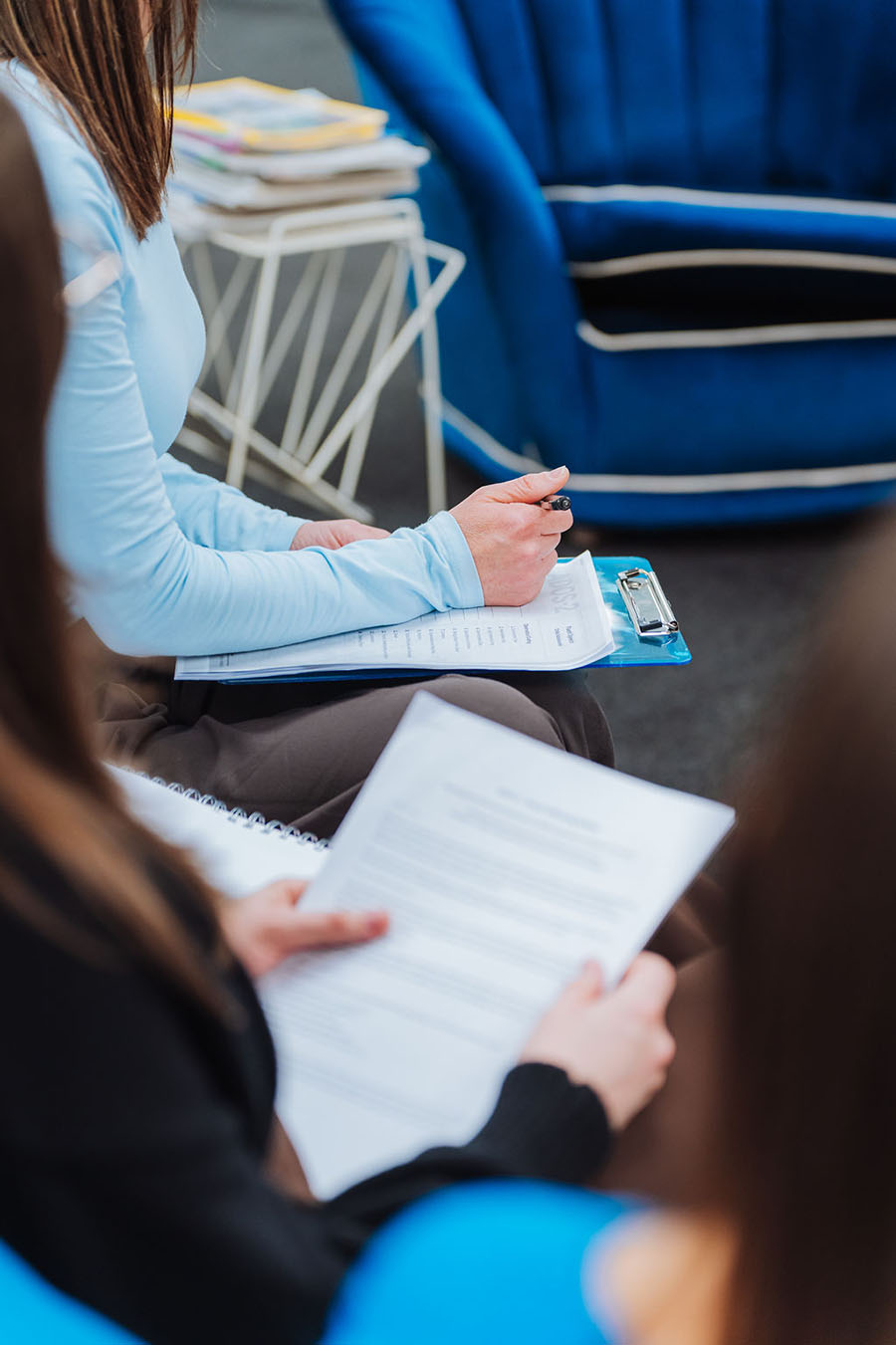 Totally Psyched team members taking notes on clipboards during a training session