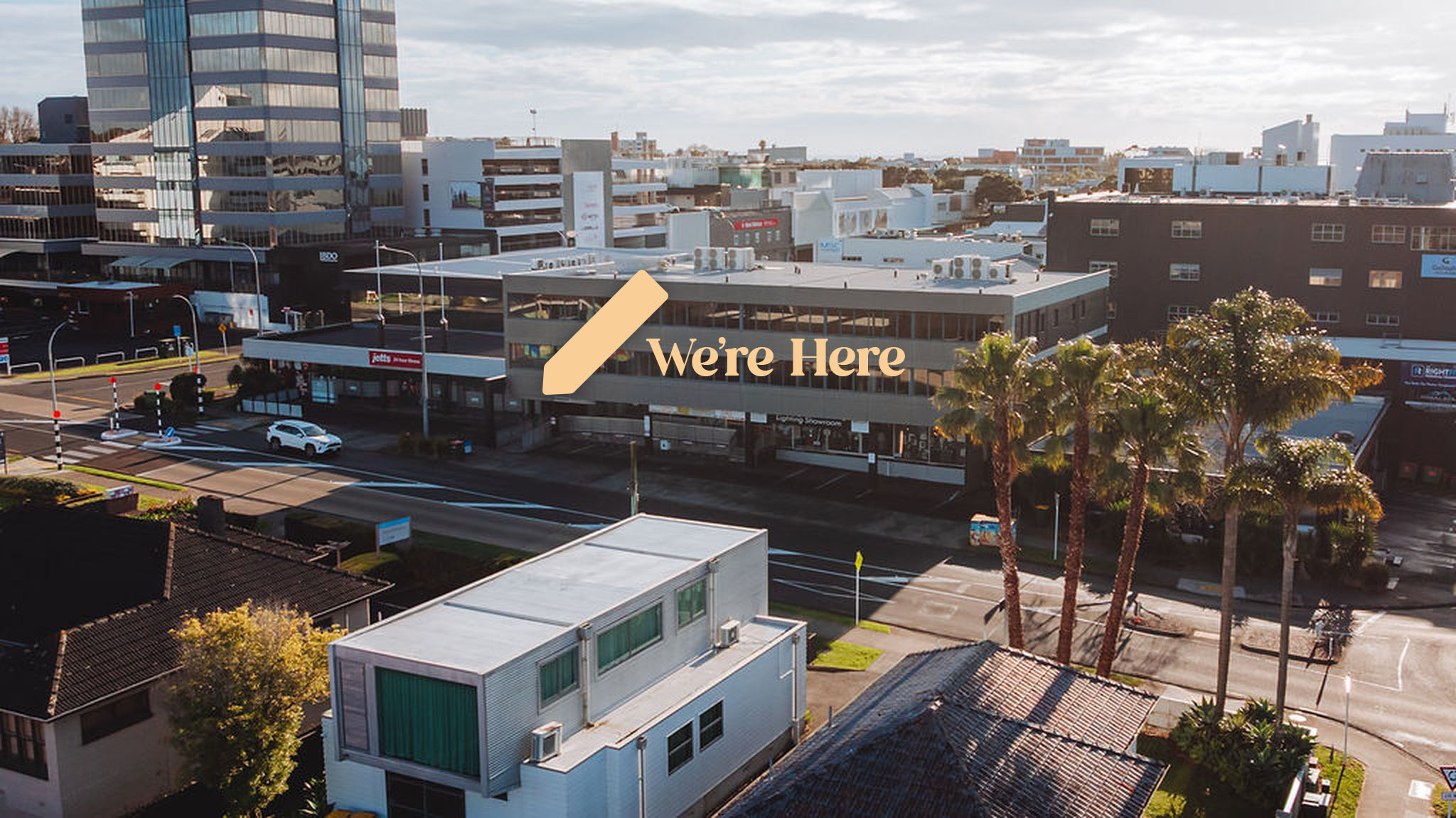Street view of the Totally Psyched building on Auburn Street with an arrow pointing to the ground-floor entrance