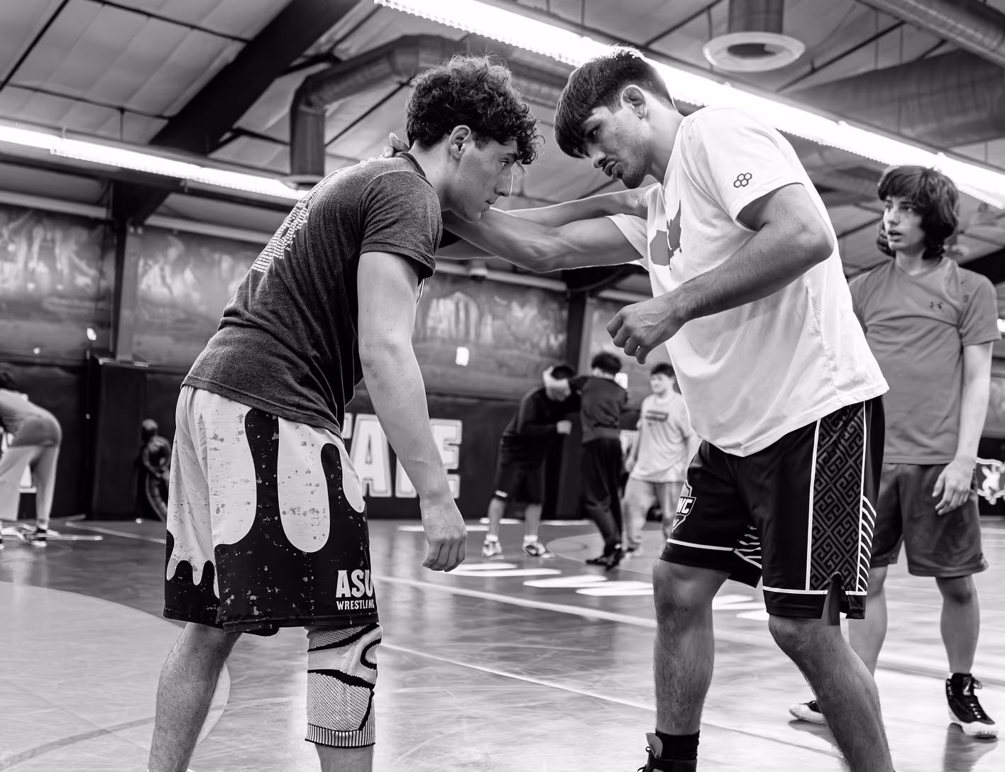 Southwest Wrestling Club wrestler helping a teammate during a training session