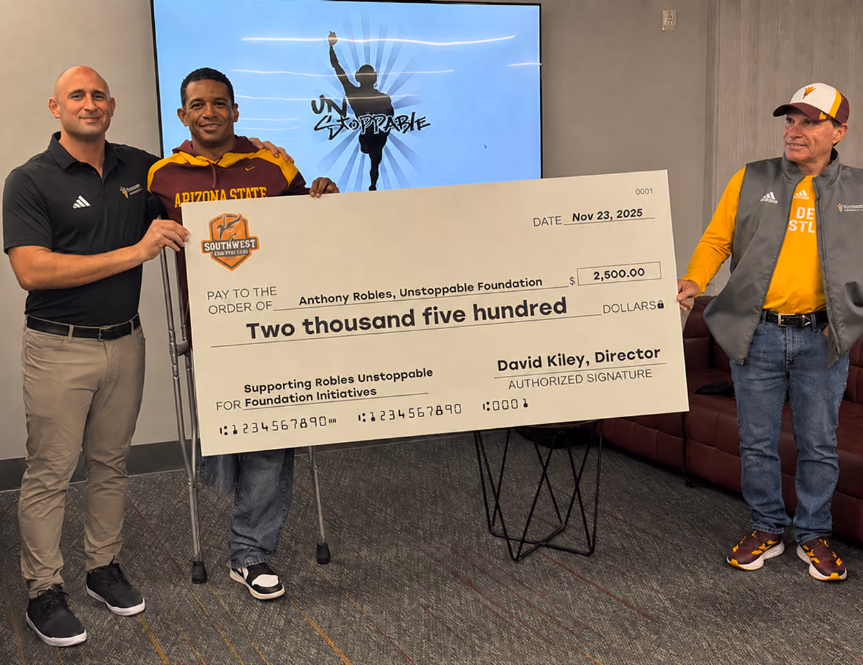Southwest Wrestling Club presenting a donation to Uncommon Sports Group