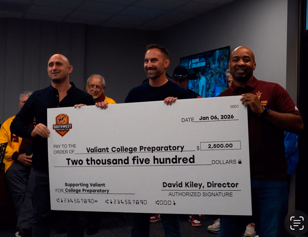 Southwest Wrestling Club presenting a donation to Valiant College Preparatory