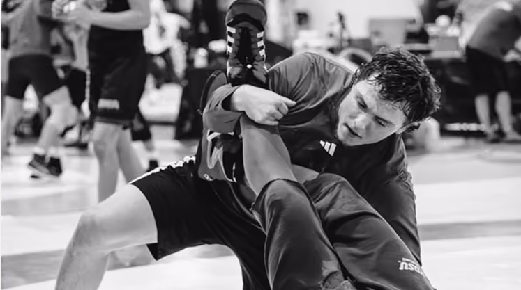Wrestler receiving individual coaching during a training session