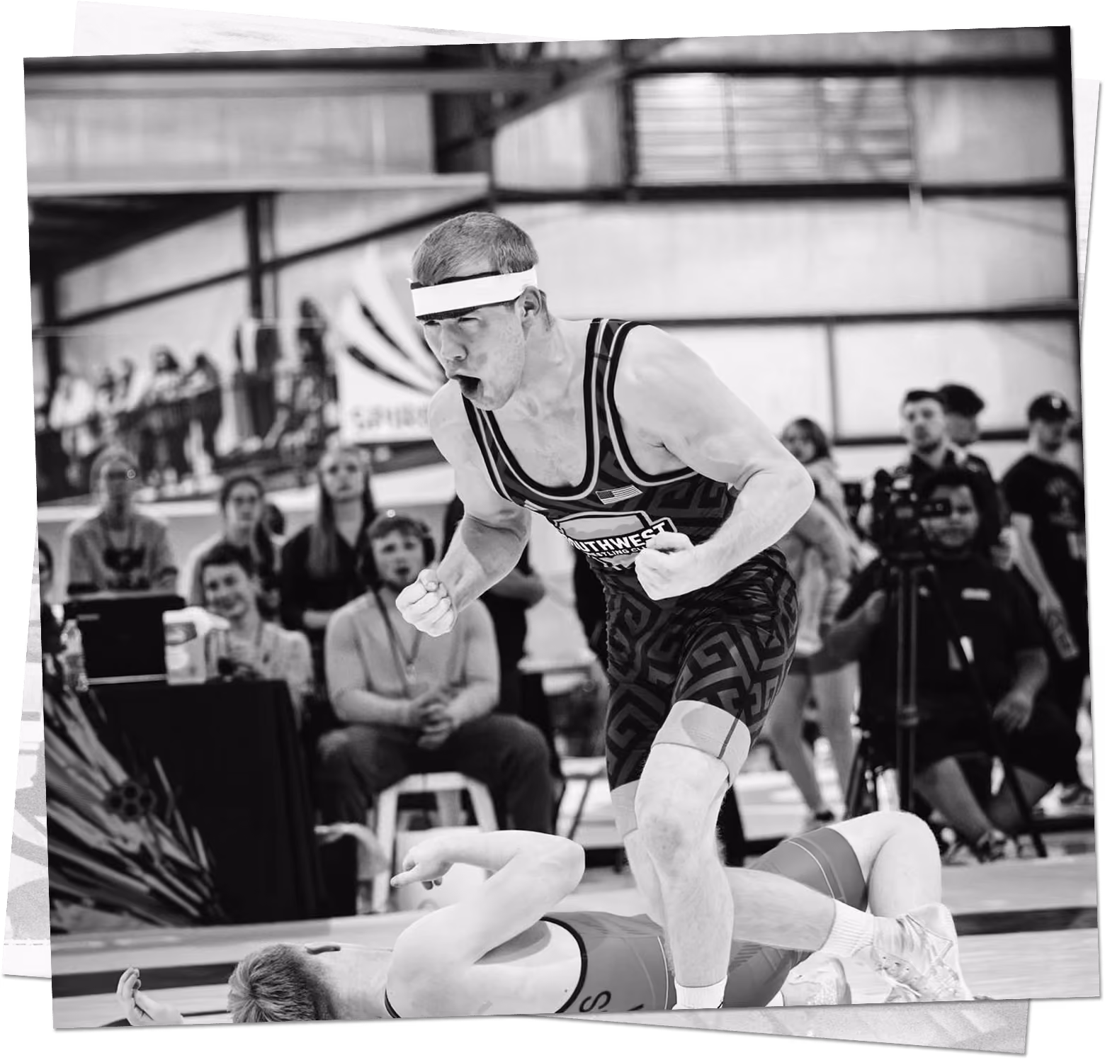 Wrestler celebrating a victory during a college wrestling match